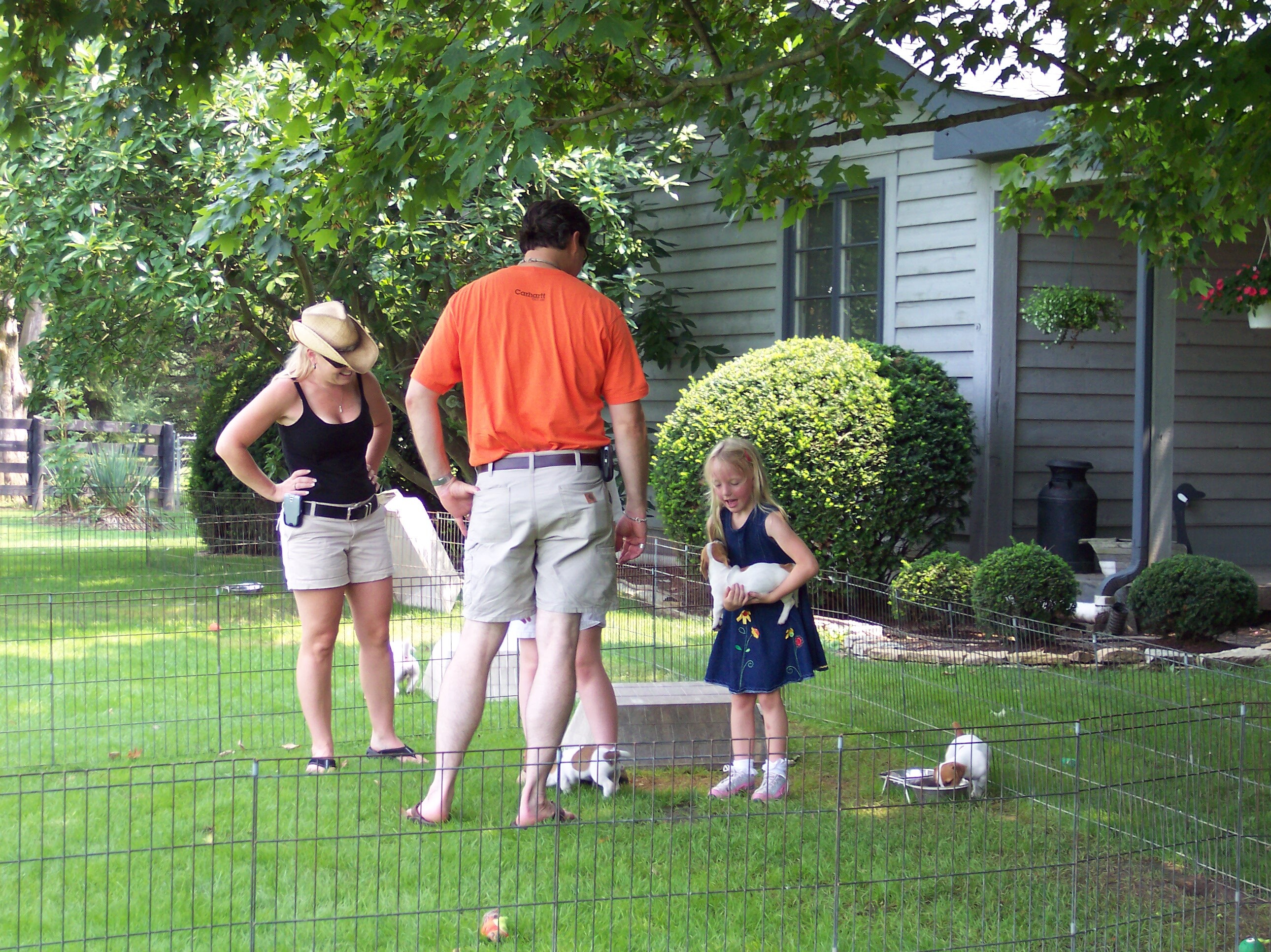 Family playing with Shorty Jacks in a fenced area